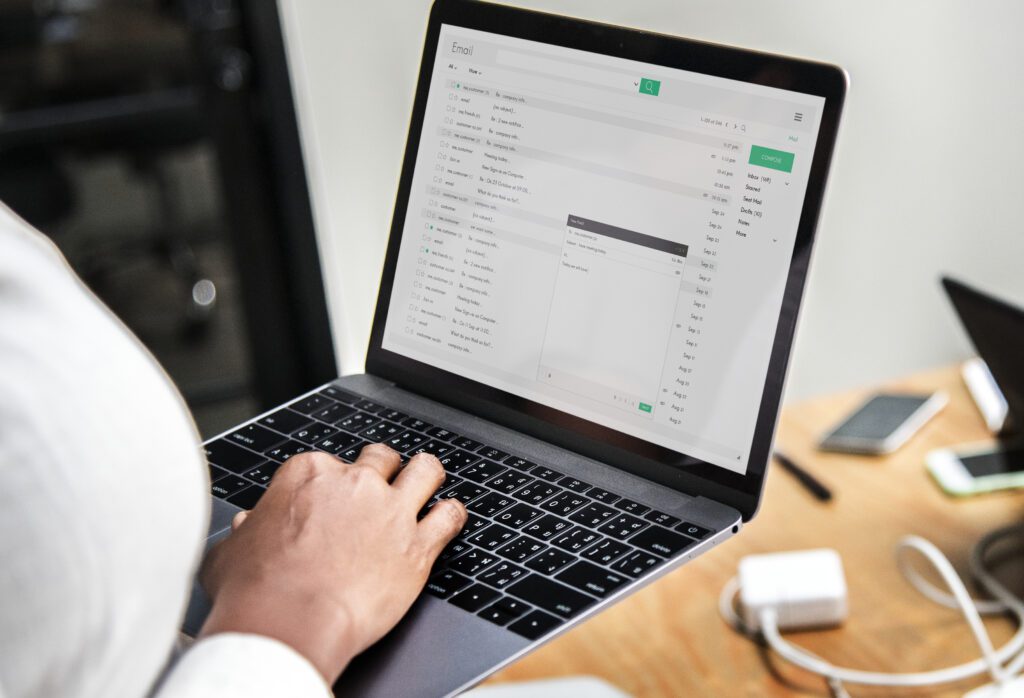 a woman typing on a laptop, Personalizing E-mails
