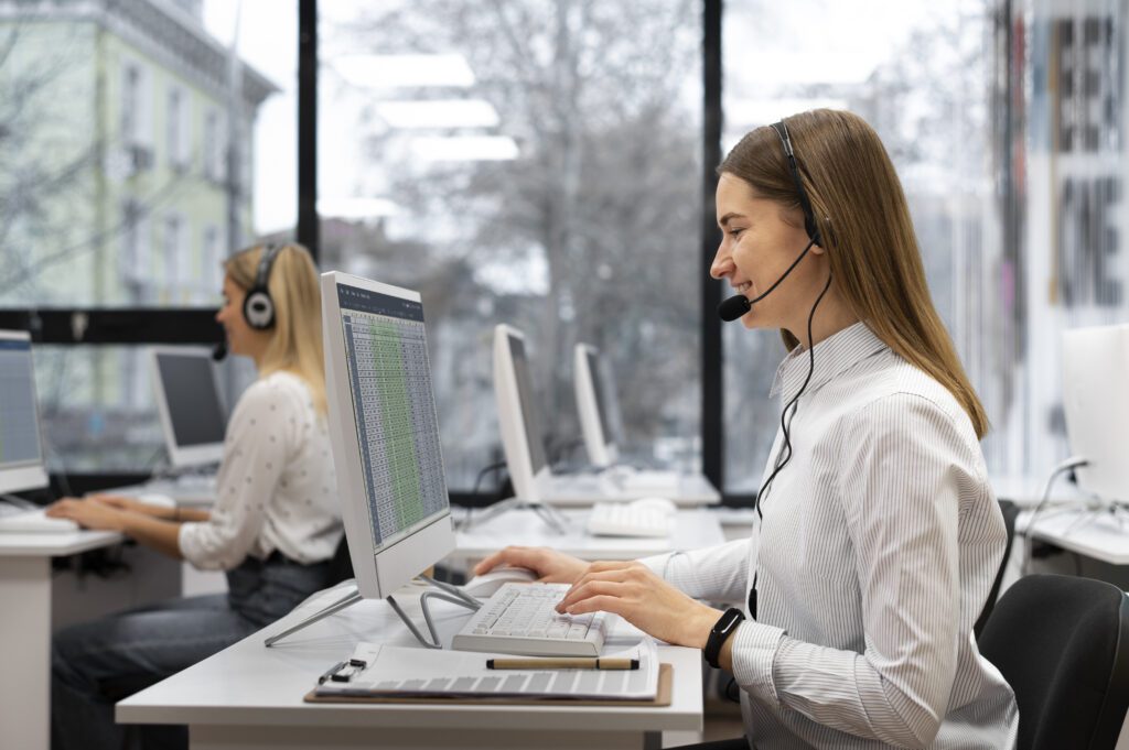a woman wearing a headset and using a computer answering an Inbound call center