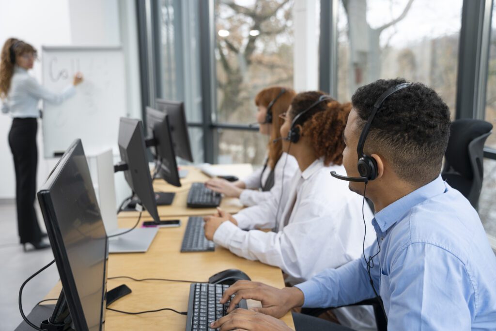 a group of people sitting at computers discussing about E-commerce conversion rates