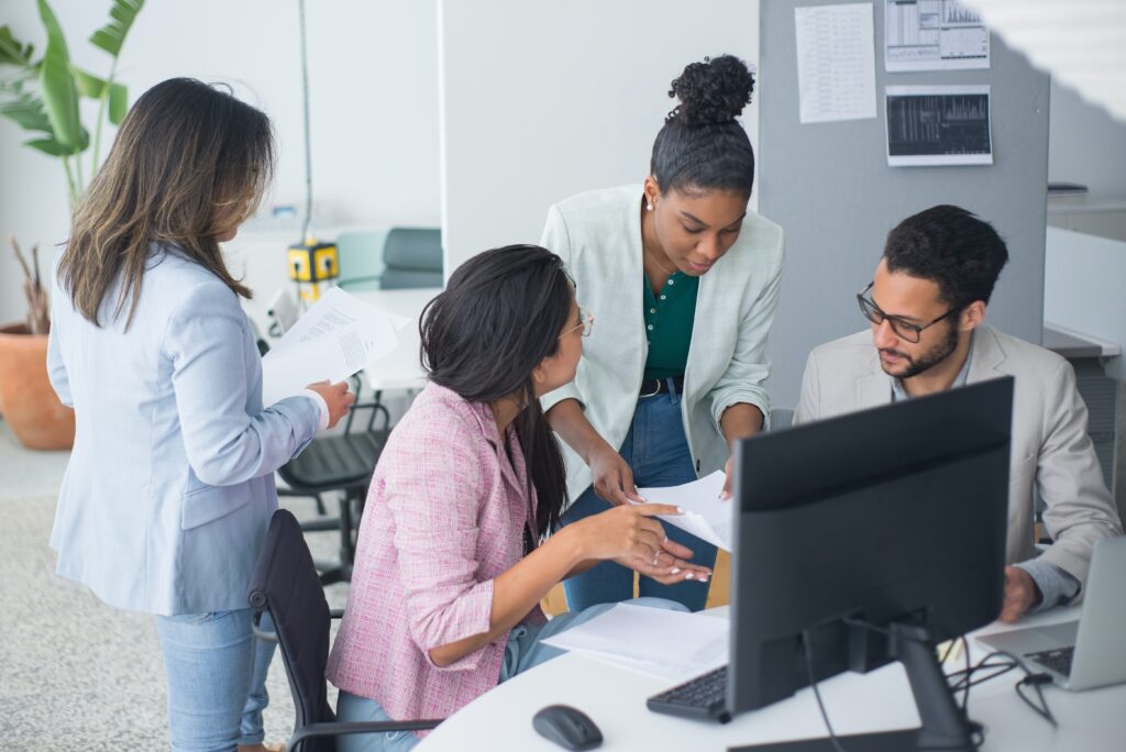 a group of man and a woman discussing an eor compliance