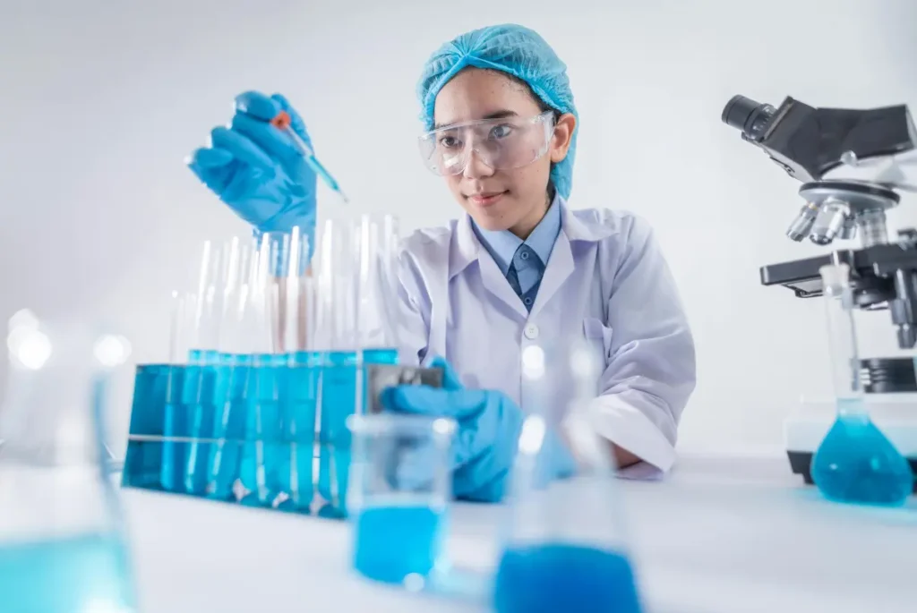 A woman in a lab coat holds a test tube, symbolizing the importance of clinical trial participation for medical advancements.