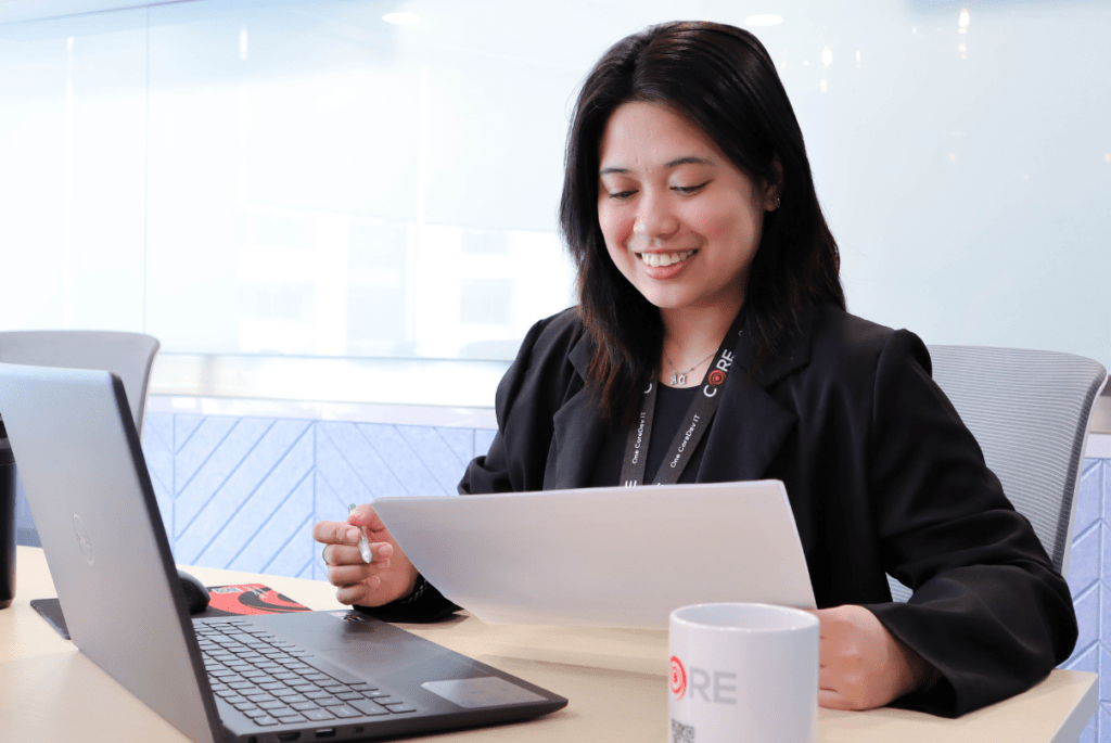 A woman focused at her desk, strategizing outsourcing for remote e-learning teams.