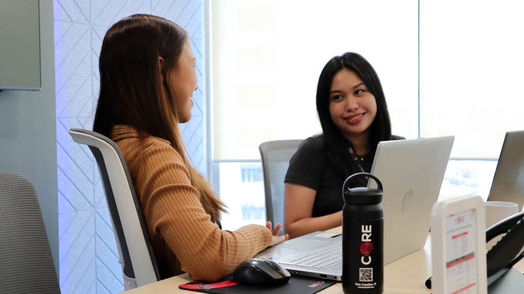 female employees smiling with laptops from One CoreDev IT (CORE) offshoring to the philippines company
