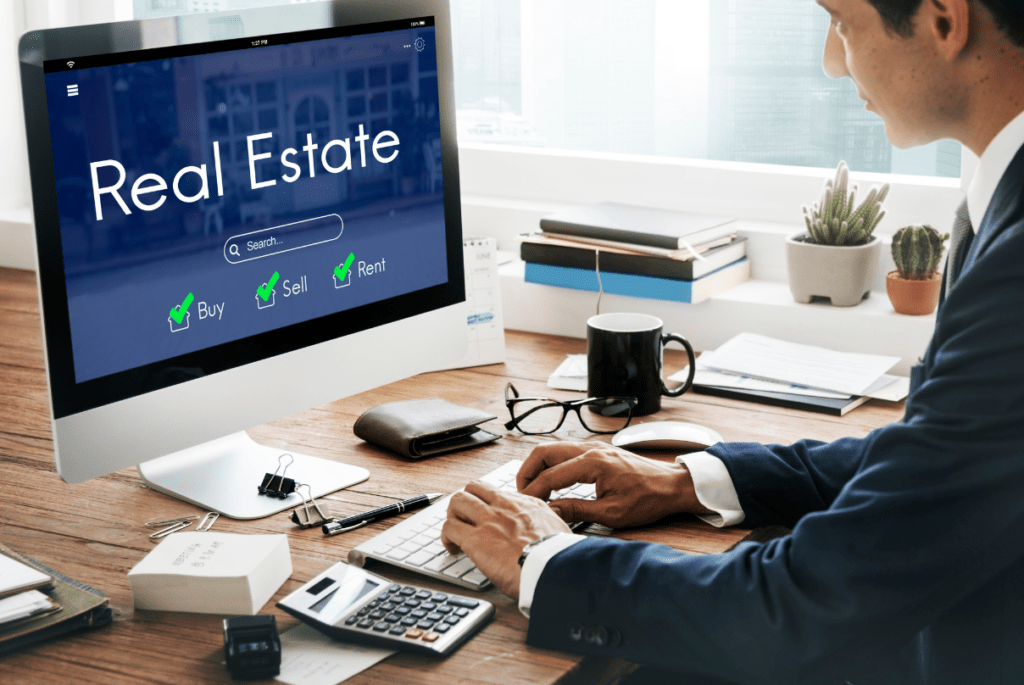 Man working on a computer displaying real estate data, illustrating cloud computing applications in the industry.
