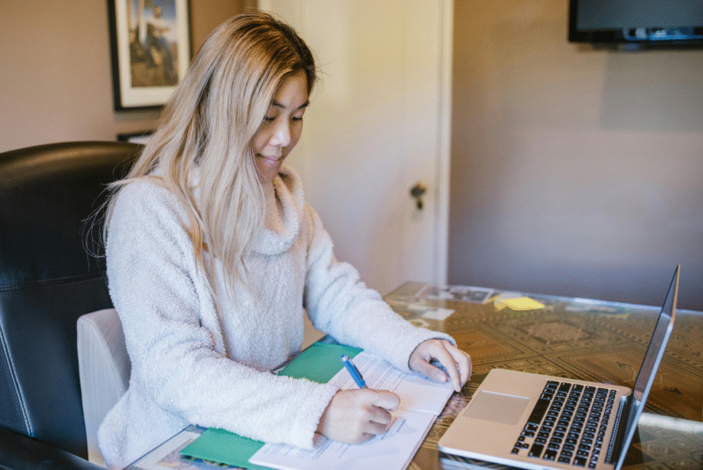 Filipino professional writing down the remote work tools Philippines