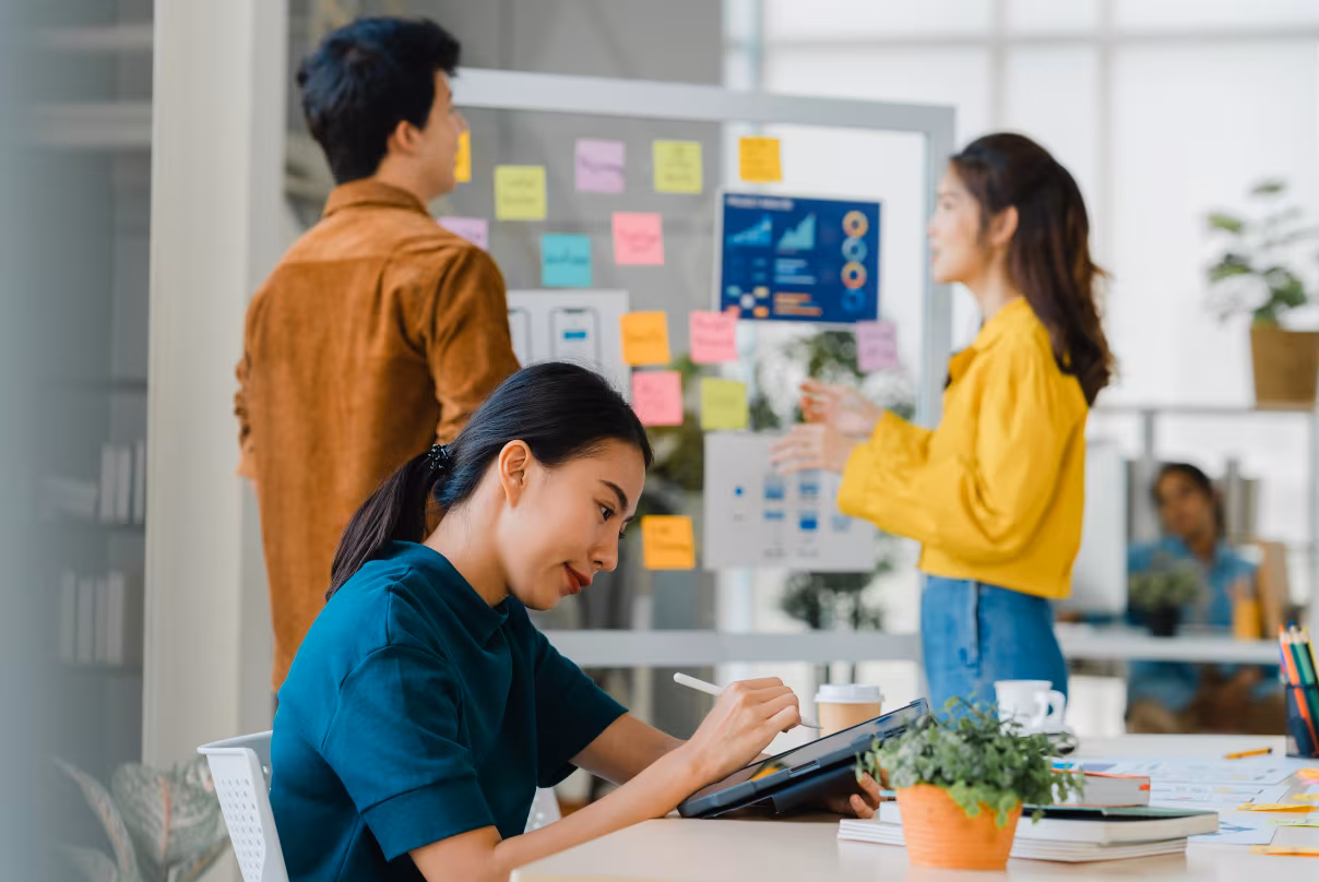A diverse group of professionals collaborating in a modern office setting, emphasizing employer branding in the Philippines.