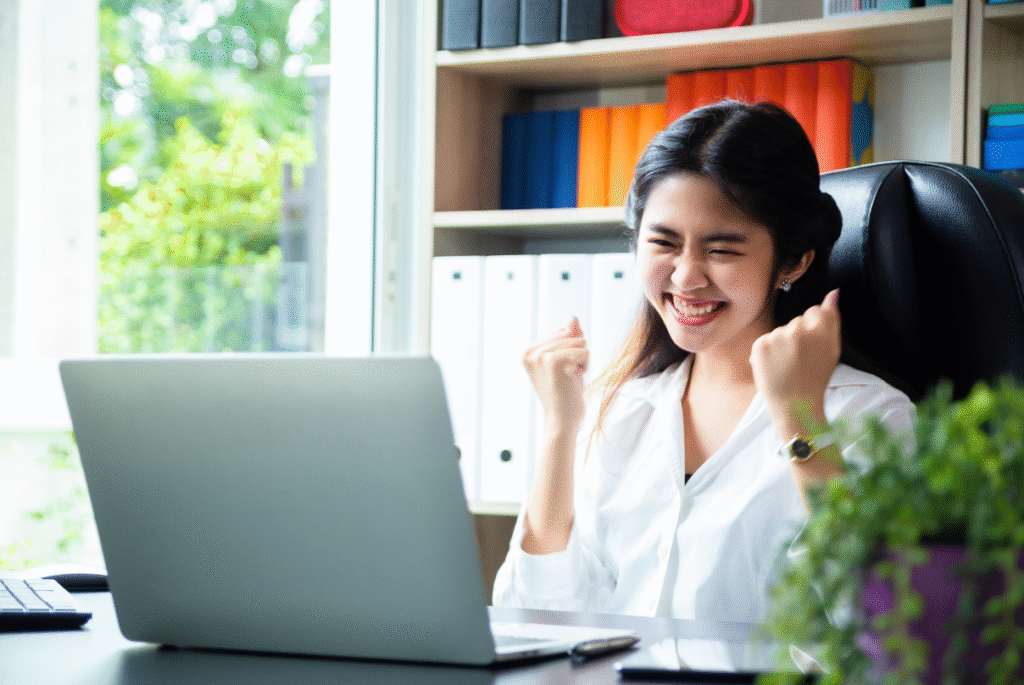 A woman sitting at her desk, working on her laptop, reflecting on special non-working holiday pay in the Philippines.