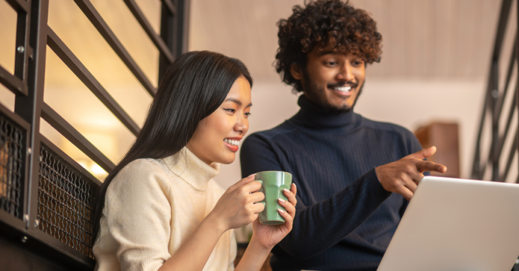 male and female employee of Philippine GCC looking at laptop